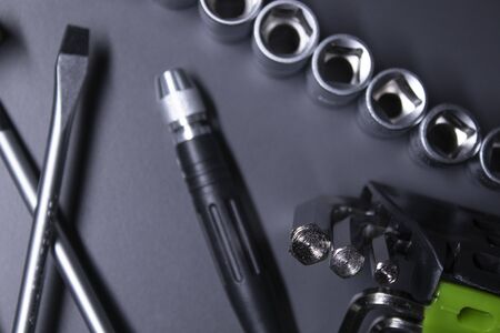 A set of building tools and instruments for repair in black and green colour. Must-have for men. Equipment for building. Repair tool kit. construction concept. gray background . High quality photoの写真素材