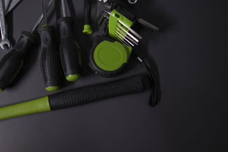 A set of building tools and instruments for repair in black and green colour. Must-have for men. Equipment for building. Repair tool kit. construction concept. gray background . High quality photoの写真素材