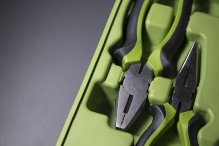 A set of building tools and instruments for repair in black and green colour. Must-have for men. Equipment for building. Repair tool kit. construction concept. gray background . High quality photoの写真素材