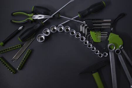 A set of building tools and instruments for repair in black and green colour. Must-have for men. Equipment for building. Repair tool kit. construction concept. gray background . High quality photoの写真素材