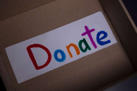 Donate sign handwritten with multicoloured letters in a box. donation concept. Context of The Coronavirus Pandemic. copy space. High quality photoの写真素材