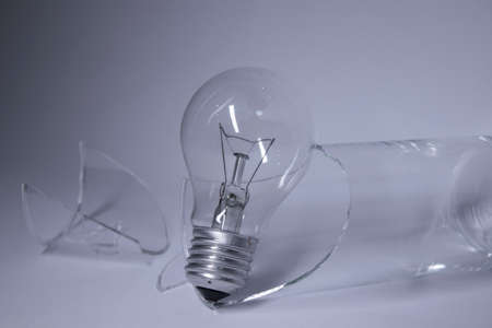light bulb in a broken glass on a white background. Copy space. Isolated. High quality photoの写真素材