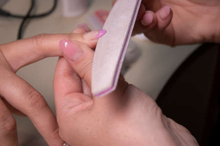 the process of doing manicure. beauty concept. Gel polish, shellac. High quality photoの写真素材