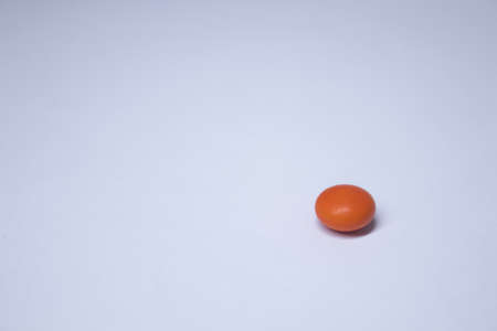 orange tablet - pill on a white background. medicine and disease concept. Isolated. High quality...
