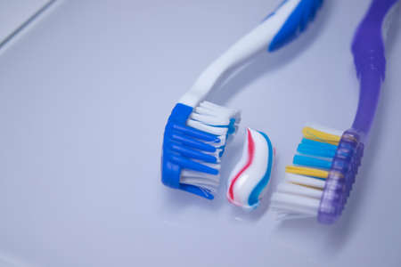 two toothbrushes on a white background next to the toothpaste. healthy and clean teeth concept,...