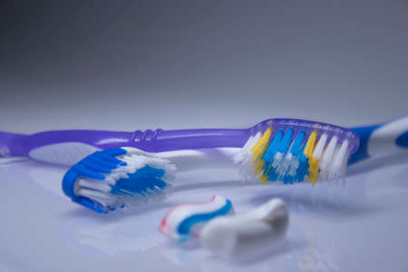 two toothbrushes on a white background next to the toothpaste. healthy and clean teeth concept,...