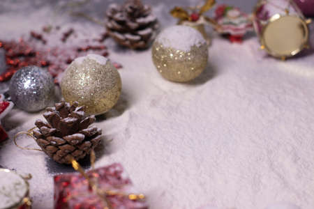 New Years decorations, decorative elements - in the snow. Christmas trees, balls, snowflakes, gifts, cones. Christmas mood. Flatly photo.の写真素材