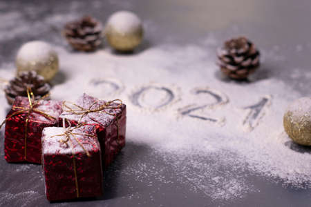 Christmas decorations, decor elements in the snow. golden balls and cones. Finger-drawn 2021 in the snow. Christmas mood. Flatly photo.の写真素材