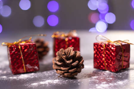Christmas decorations in the snow - gifts and cones. Christmas mood.