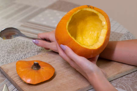 the process of making a Halloween pumpkin. cleansing of seeds. horror theme and Halloween.の写真素材