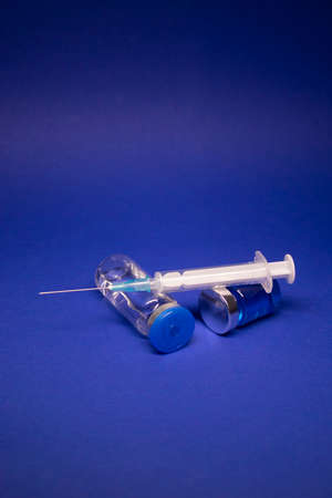 Vaccine bottle phial with no label, medical syringe injection needle.の写真素材