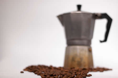 geyser coffee maker or moka pot isolated on white background with coffee beans nearby.の写真素材