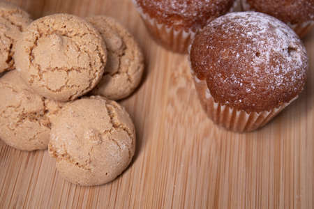 muffins, almond amaretti and oat cookies on wooden stand board. concept of sweet bakeryの写真素材