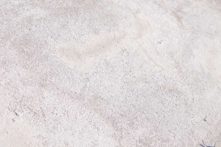 white cement. texture of stone concrete, rock plastered wall. cracked sand brick. pastel background white gray solid grain floorの写真素材