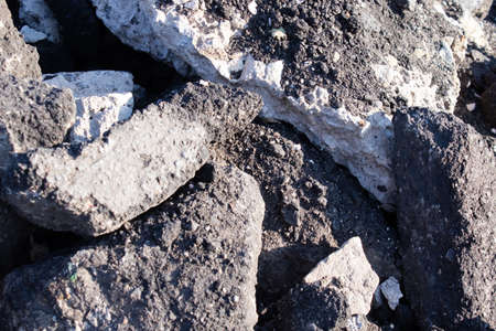 close-up of Old cracked asphalt pavement. concept of reduce reuse recycle. pile of smashed concrete....