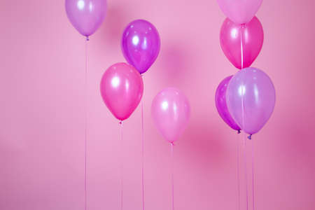 floating Colorful pink party balloons on pink pastel background. Space for text. Minimal idea...