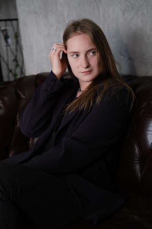 portrait of confident woman in black in dark room. pensive serious people. business woman. feminine....