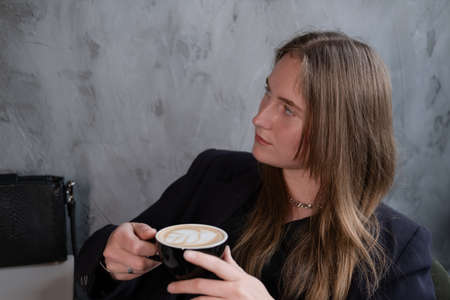 charming confident brunette woman in a cafe with coffee. coffee break. business woman.