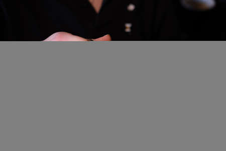 latte art by barista. pouring milk in coffee. dark coffee house.の写真素材