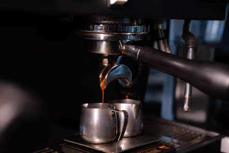 Close-up of Espresso machine making coffee in pub, bar, restaurant. Professional coffee brewing. Coffee Shop Cafeteria Restaurant Service Concept.の写真素材