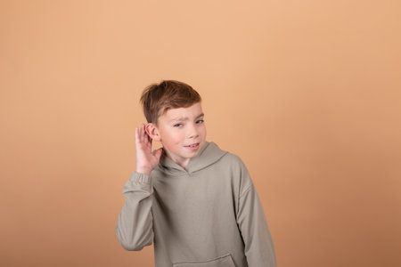 Teen boy portrait teenager isolated on brown background. emotions on face. feelings and facial expression concept. advertisement. copy free space for text.の写真素材