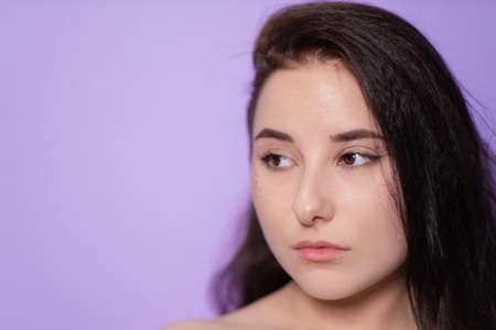 pretty brunette girl woman on Very Peri background. trendy color 2022. light purple.の写真素材
