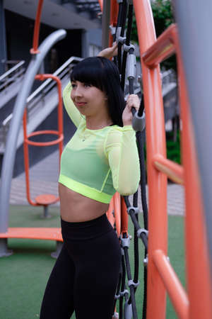 Fitness sport girl in fashion sportswear doing yoga fitness exercise on sport trendy playground on...