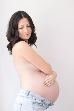happy pretty woman enjoying pregnancy. mother to be is expecting parent. cute big tummy. pregnant...