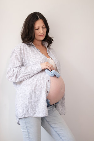 happy pretty woman enjoying pregnancy. mother to be is expecting parent. cute big tummy. pregnant...