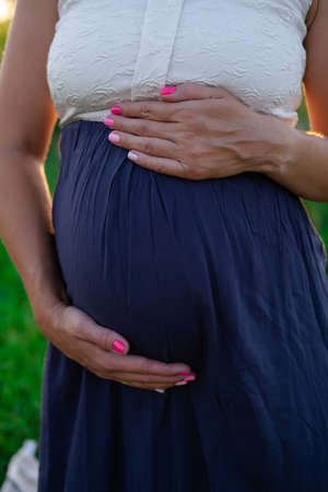 close up of cute Pregnant tummy on nature background. motherhood conceptの写真素材