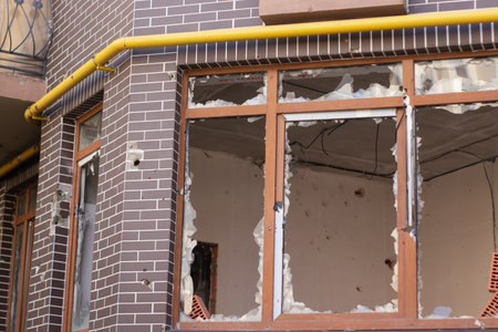 consequences of russian war crimes. destroyed houses in irpin city, ukraine. mortar shell hit someone home during war.の写真素材