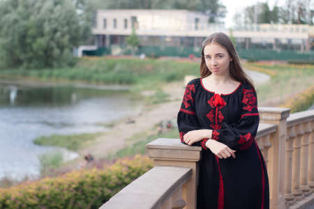 girl in national traditional ukrainian clothes. black and red embroidered dress. woman model posing...