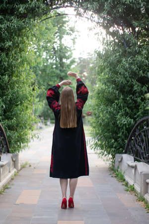 portrait of young woman wearing black and red vyshyvanka. national embroidered Ukrainian shirt. girl...