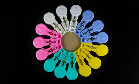 Colored clothespins on black background