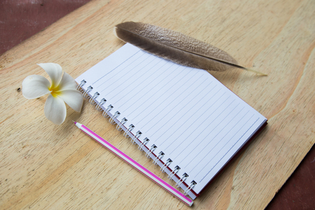 white notebook on the wooden tableの写真素材