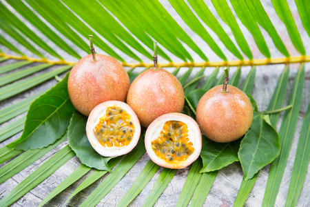 Passion fruits on green leaf backgroundの写真素材