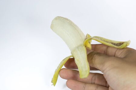 hand and banana on white backgroundの写真素材