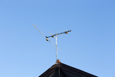 Digital TV aerial or antenna on top of a houseの写真素材