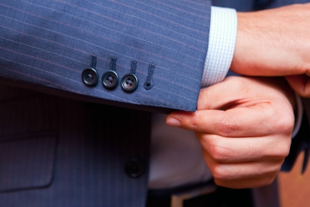 businessman correcting a sleeve