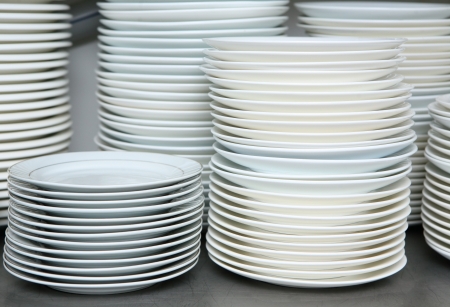 stack of clean dishes plates in the kitchenの写真素材