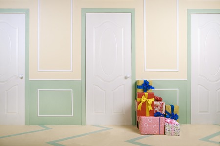 gift boxes go under the door in a bright roomの写真素材