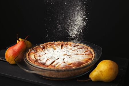 Tasty homemade pear pie on wooden backgroundの写真素材