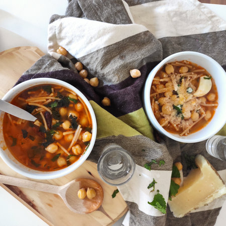 Italian spicy dish Chickpeas pasta soup with paresan cheese and persilの写真素材