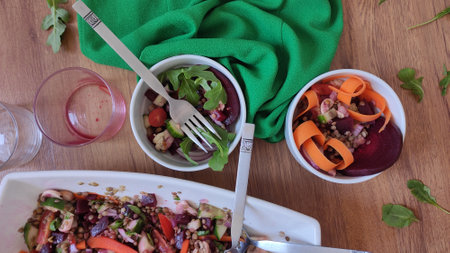 Mixed and colorful salad bowl with many veggies, purple beetroots, mushrooms, lentils, tomatoes, cucumber, rocket and onionの写真素材