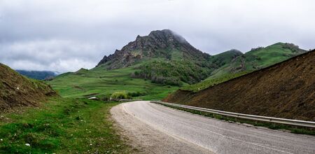 Sharp panoramic photo of mountain road wirh cloud sky, Caucase, Russiaの写真素材