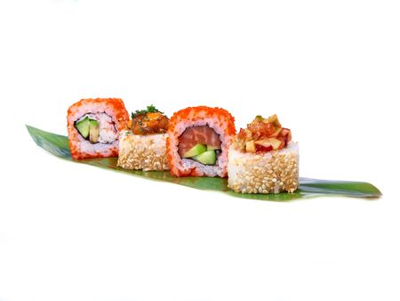 Sushi rolls row on bamboo leaf isolated on whiteの写真素材
