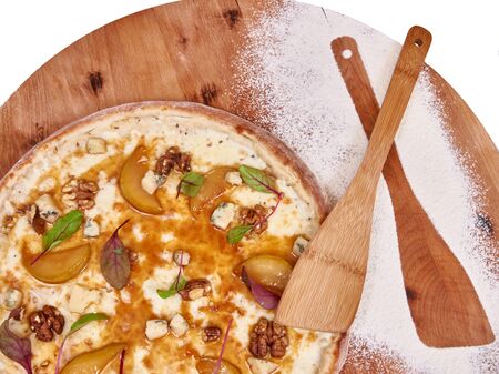 Pizza on wood decorated with spreaded wheatの写真素材