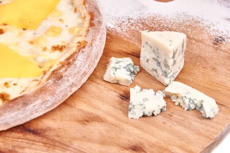 Cheese Pizza on wood decorated with blue cheeseの写真素材