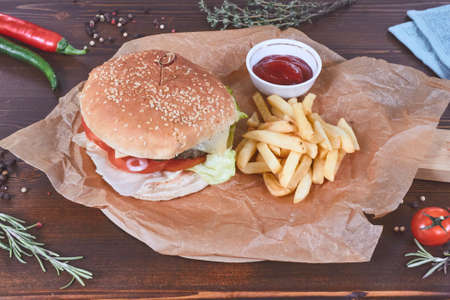 Burger with fries on wood