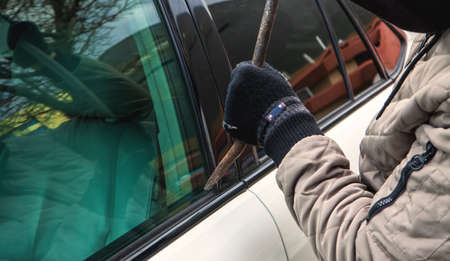 car theft, thief trying to break into the vehicleの写真素材